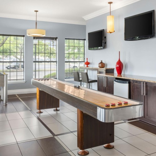 a clubroom with table games and chairs