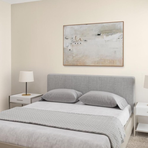 a bedroom with a bed and lamps