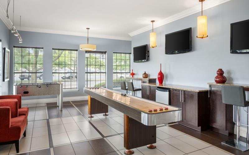 a clubroom with table games and chairs
